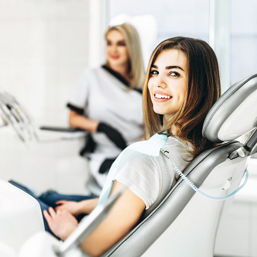 Young woman smiling in the dental chair