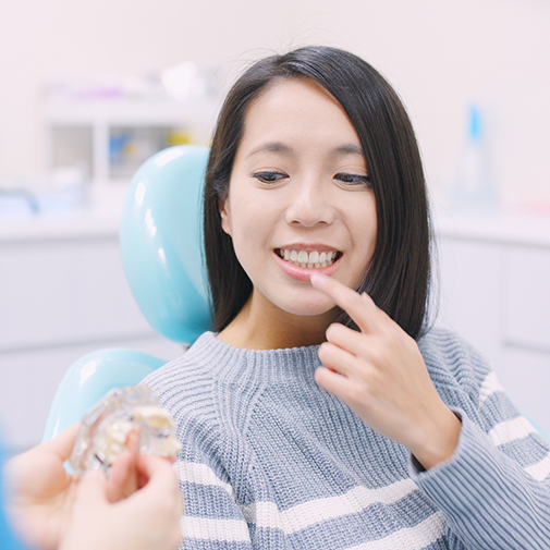 Dental patient pointing to her teeth