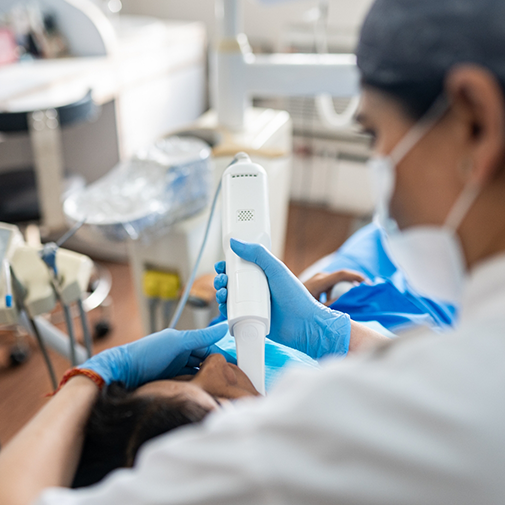 Dentist capturing digital impressions of a patient's teeth