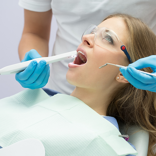Dentist taking close up photos of a patient's teeth