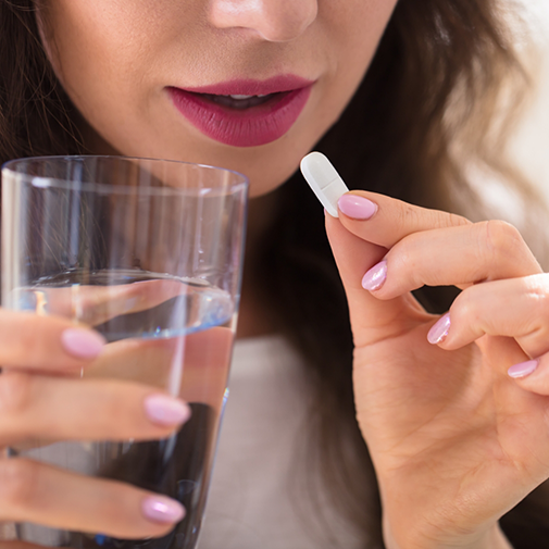 Woman taking a pill