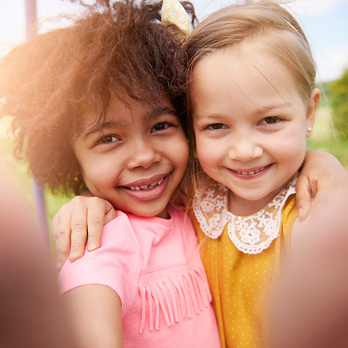 Selfie of two young girls at a playground