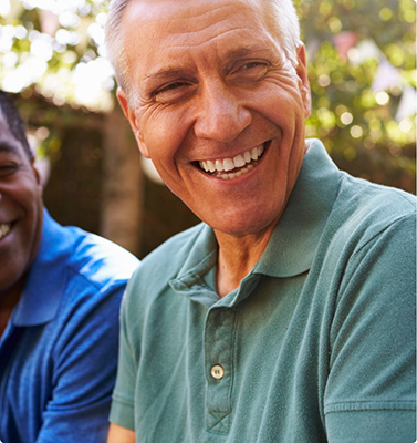 Three men laughing together outdoors