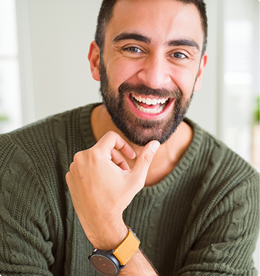 Smiling man in a dark green sweater