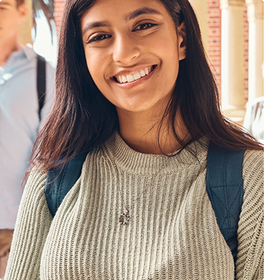 Smiling woman in a gray sweater