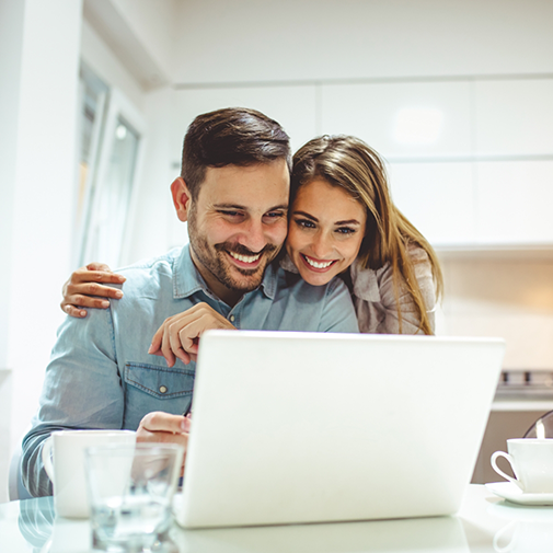 Smiling man and woman on a video call on a laptop