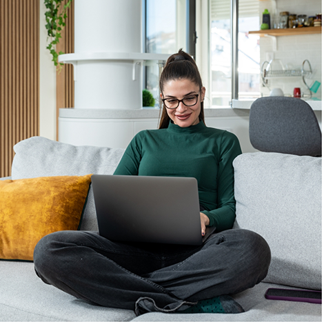 Woman using a laptop on a couch